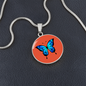 Stunning Blue Butterfly Personalised Engraved Circle Necklace on terracotta orange background. Polished surgical steel or with an 18k gold finish option. Necklace: 18-22" adjustable.
Circle Pendant: 0.9” x 0.9” (23.5mm x 23.5mm)
