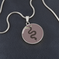 Cinnamon Slate Snake Round Disc Necklace, Personalized Engraved Circle Necklace. Polished surgical steel or with an 18k gold finish option. Necklace: 18-22" adjustable.
Circle Pendant: 0.9” x 0.9” (23.5mm x 23.5mm)
