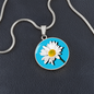 Daisy Birth Flower April Graphic Epoxy Disc Necklace. Clear shiny epoxy shows a white petal flower with yellow canter on a light blue background. The jewellery is made of high quality surgical steel or with an 18k gold finish option with an option to engrave a short love you message or special date. Luxury Necklace: 18-22" (45-56cm) adjustable
Circle Pendant: 0.9” x 0.9” (23.5mm x 23.5mm)