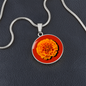 Marigold Birth Flower October Graphic Epoxy Disc Necklace. Clear shiny epoxy shows an orange petal flower on a darker red background. The jewellery is made of high quality surgical steel or with an 18k gold finish option with an option to engrave a short love you message or special date. Luxury Necklace: 18-22" (45-56cm) adjustable
Circle Pendant: 0.9” x 0.9” (23.5mm x 23.5mm)