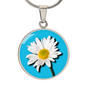 Daisy Birth Flower April Graphic Epoxy Disc Necklace. Clear shiny epoxy shows a white petal flower with yellow canter on a light blue background. The jewellery is made of high quality surgical steel or with an 18k gold finish option with an option to engrave a short love you message or special date. Luxury Necklace: 18-22" (45-56cm) adjustable
Circle Pendant: 0.9” x 0.9” (23.5mm x 23.5mm)