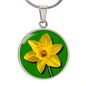 Daffodil Birth Flower March Graphic Epoxy Disc Necklace. Clear shiny epoxy shows a yellow petal flower on a green background. The jewellery is made of high quality surgical steel or with an 18k gold finish option with an option to engrave a short love you message or special date. Luxury Necklace: 18-22" (45-56cm) adjustable
Circle Pendant: 0.9” x 0.9” (23.5mm x 23.5mm)