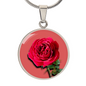 Rose Birth Flower June Graphic Epoxy Disc Necklace. Clear shiny epoxy shows a red petal flower and green stem on a pink background. The jewellery is made of high quality surgical steel or with an 18k gold finish option with an option to engrave a short love you message or special date. Luxury Necklace: 18-22" (45-56cm) adjustable
Circle Pendant: 0.9” x 0.9” (23.5mm x 23.5mm)