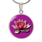 Water Lily Birth Flower July Graphic Epoxy Disc Necklace. Clear shiny epoxy shows a light pink petal flower on a darker pink background. The jewellery is made of high quality surgical steel or with an 18k gold finish option with an option to engrave a short love you message or special date. Luxury Necklace: 18-22" (45-56cm) adjustable
Circle Pendant: 0.9” x 0.9” (23.5mm x 23.5mm)