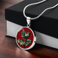 Holly Birth Flower December Graphic Epoxy Disc Necklace. Clear shiny epoxy shows a red berry on green spikey leaf with a darker red background. The jewellery is made of high quality surgical steel or with an 18k gold finish option with an option to engrave a short love you message or special date. Luxury Necklace: 18-22" (45-56cm) adjustable
Circle Pendant: 0.9” x 0.9” (23.5mm x 23.5mm)