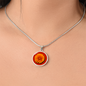 Marigold Birth Flower October Graphic Epoxy Disc Necklace. Clear shiny epoxy shows an orange petal flower on a darker red background. The jewellery is made of high quality surgical steel or with an 18k gold finish option with an option to engrave a short love you message or special date. Luxury Necklace: 18-22" (45-56cm) adjustable
Circle Pendant: 0.9” x 0.9” (23.5mm x 23.5mm)