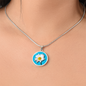 Daisy Birth Flower April Graphic Epoxy Disc Necklace. Clear shiny epoxy shows a white petal flower with yellow canter on a light blue background. The jewellery is made of high quality surgical steel or with an 18k gold finish option with an option to engrave a short love you message or special date. Luxury Necklace: 18-22" (45-56cm) adjustable
Circle Pendant: 0.9” x 0.9” (23.5mm x 23.5mm)