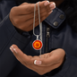 Marigold Birth Flower October Graphic Epoxy Disc Necklace. Clear shiny epoxy shows an orange petal flower on a darker red background. The jewellery is made of high quality surgical steel or with an 18k gold finish option with an option to engrave a short love you message or special date. Luxury Necklace: 18-22" (45-56cm) adjustable
Circle Pendant: 0.9” x 0.9” (23.5mm x 23.5mm)