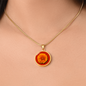 Marigold Birth Flower October Graphic Epoxy Disc Necklace. Clear shiny epoxy shows an orange petal flower on a darker red background. The jewellery is made of high quality surgical steel or with an 18k gold finish option with an option to engrave a short love you message or special date. Luxury Necklace: 18-22" (45-56cm) adjustable
Circle Pendant: 0.9” x 0.9” (23.5mm x 23.5mm)