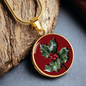 Holly Birth Flower December Graphic Epoxy Disc Necklace. Clear shiny epoxy shows a red berry on green spikey leaf with a darker red background. The jewellery is made of high quality surgical steel or with an 18k gold finish option with an option to engrave a short love you message or special date. Luxury Necklace: 18-22" (45-56cm) adjustable
Circle Pendant: 0.9” x 0.9” (23.5mm x 23.5mm)