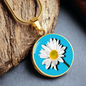 Daisy Birth Flower April Graphic Epoxy Disc Necklace. Clear shiny epoxy shows a white petal flower with yellow canter on a light blue background. The jewellery is made of high quality surgical steel or with an 18k gold finish option with an option to engrave a short love you message or special date. Luxury Necklace: 18-22" (45-56cm) adjustable
Circle Pendant: 0.9” x 0.9” (23.5mm x 23.5mm)