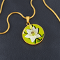 Lily Birth Flower May Graphic Epoxy Disc Necklace. Clear shiny epoxy shows a white petal flower with green stem on a lime green background. The jewellery is made of high quality surgical steel or with an 18k gold finish option with an option to engrave a short love you message or special date. Luxury Necklace: 18-22" (45-56cm) adjustable
Circle Pendant: 0.9” x 0.9” (23.5mm x 23.5mm)