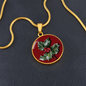 Holly Birth Flower December Graphic Epoxy Disc Necklace. Clear shiny epoxy shows a red berry on green spikey leaf with a darker red background. The jewellery is made of high quality surgical steel or with an 18k gold finish option with an option to engrave a short love you message or special date. Luxury Necklace: 18-22" (45-56cm) adjustable
Circle Pendant: 0.9” x 0.9” (23.5mm x 23.5mm)
