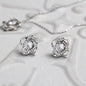 Love Knot Earring & Pendant Necklace Set. 14k white gold over finish surrounding a dazzling 6mm cubic zirconia crystal.