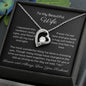 Dazzling Forever Love Necklace and heartfelt message card. This necklace features a stunning 6.5mm CZ crystal surrounded by a polished heart pendant embellished with smaller crystals. 14k white gold finish with adjustable chain length: 18" - 22" (45.72cm - 55.88cm)