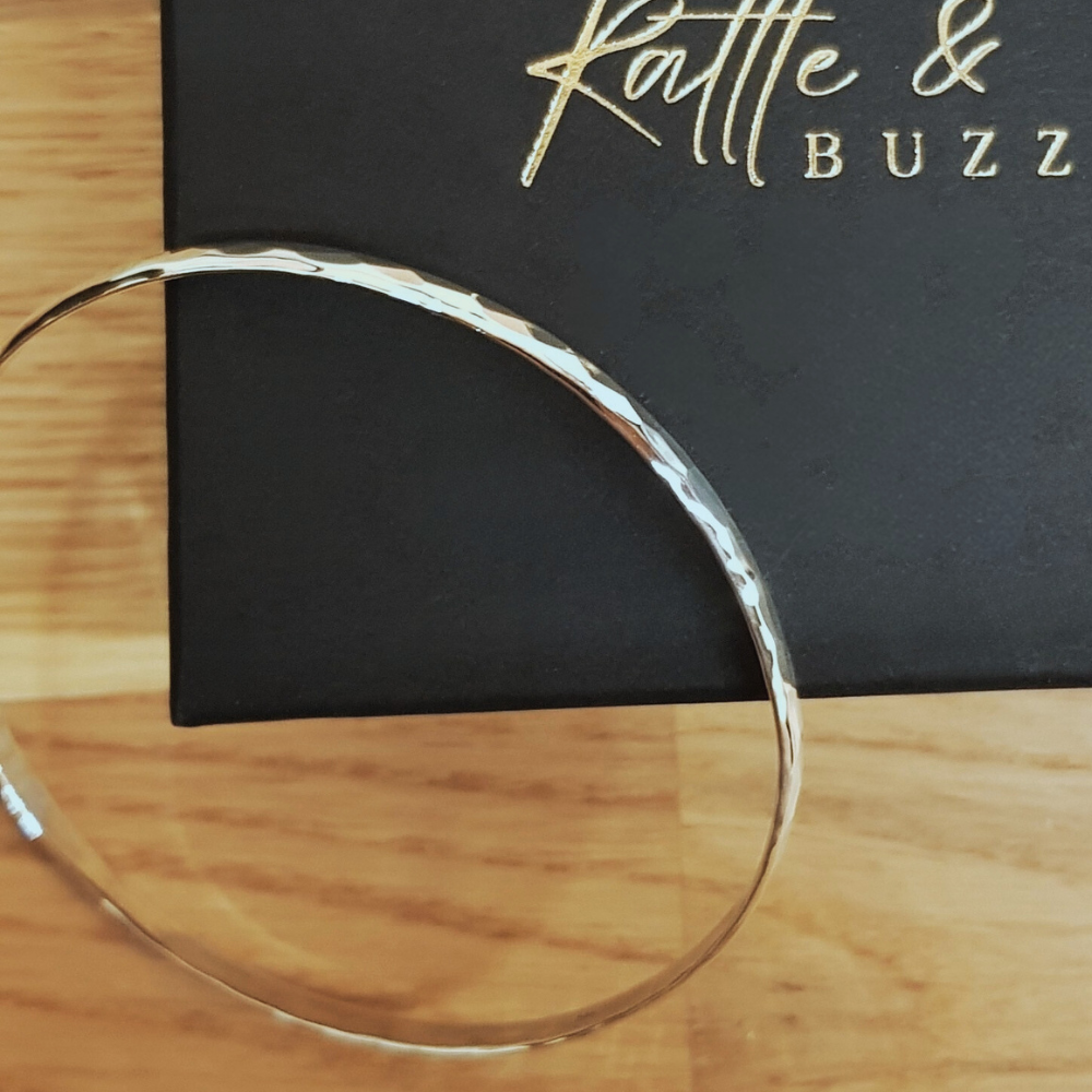 This Beautiful Silver Hammered Bangle is a 3mm wide 3mm wide Hammered Finish D shaped design in 925 silver work with a high polish and looks amazing. The 925 Silver Hammered Bangle is designed to be worn on it's own or added to in multiples. It is 65mm round and slides nicely over the hand.