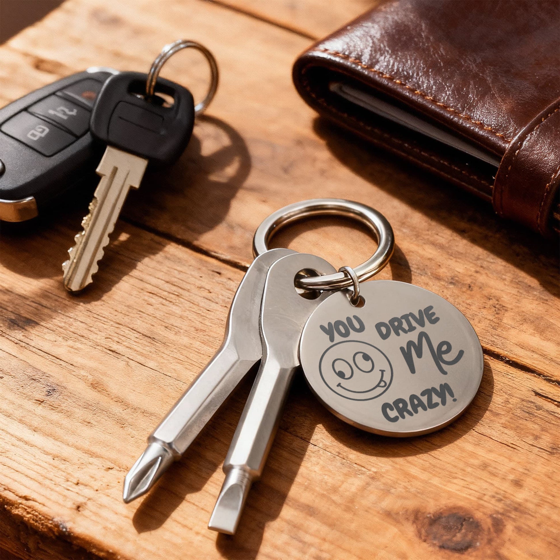 Engraved keychain screwdriver for your loved one with flathead and Philips. Cheeky message reads You drive me crazy! with a googly face. Add your own engraved message on the back. Colour Black or Silver.