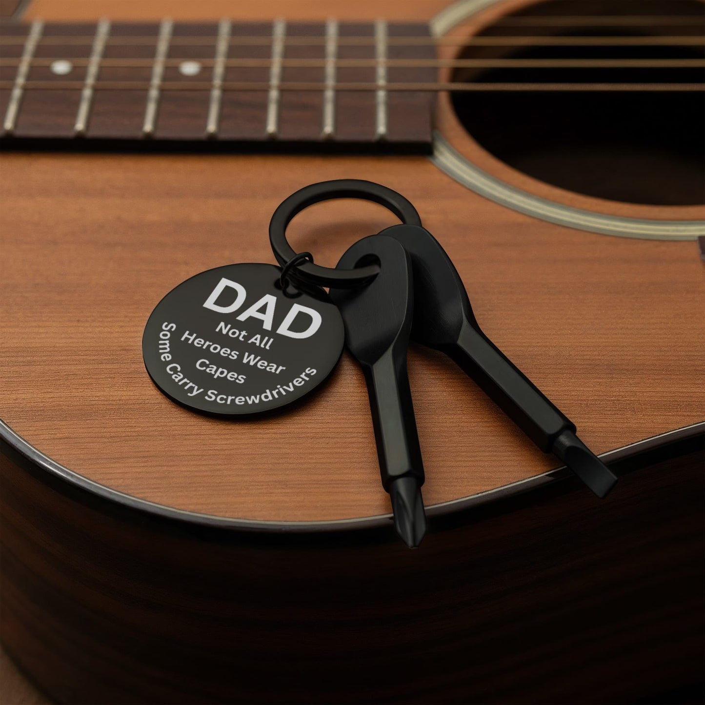 Engraved  keychain screwdriver for DAD with flathead and Philips. Message reads DAD not all heroes wear capes, some carry screwdrivers. Add your own engraved message on the back. Colour Black or Silver.