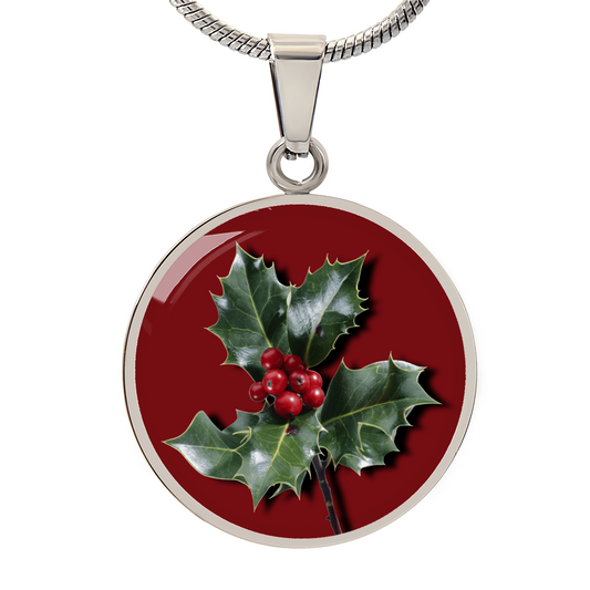 Holly Birth Flower December Graphic Epoxy Disc Necklace. Clear shiny epoxy shows a red berry on green spikey leaf with a darker red background. The jewellery is made of high quality surgical steel or with an 18k gold finish option with an option to engrave a short love you message or special date. Luxury Necklace: 18-22" (45-56cm) adjustable
Circle Pendant: 0.9” x 0.9” (23.5mm x 23.5mm)