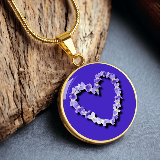 Violet Birth Flower February Graphic Epoxy Disc Necklace. Clear shiny epoxy shows purple and white violets in the shape of a heart on a Purple background. The jewellery is made of high quality surgical steel or with an 18k gold finish option with an option to engrave a short love you message or special date. Luxury Necklace: 18-22" (45-56cm) adjustable
Circle Pendant: 0.9” x 0.9” (23.5mm x 23.5mm)