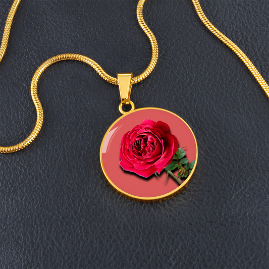 Rose Birth Flower June Graphic Epoxy Disc Necklace. Clear shiny epoxy shows a red petal flower and green stem on a pink background. The jewellery is made of high quality surgical steel or with an 18k gold finish option with an option to engrave a short love you message or special date. Luxury Necklace: 18-22" (45-56cm) adjustable
Circle Pendant: 0.9” x 0.9” (23.5mm x 23.5mm)