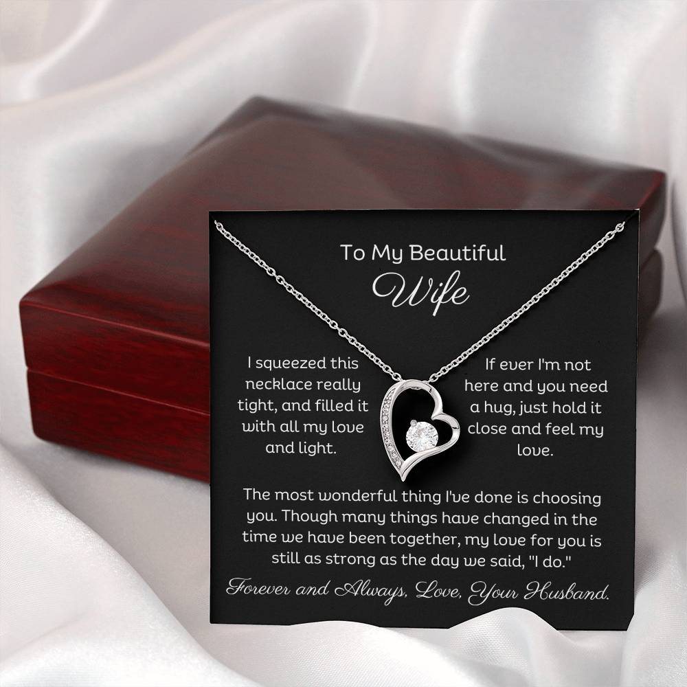Dazzling Forever Love Necklace and heartfelt message card. This necklace features a stunning 6.5mm CZ crystal surrounded by a polished heart pendant embellished with smaller crystals. 14k white gold finish with adjustable chain length: 18" - 22" (45.72cm - 55.88cm) 