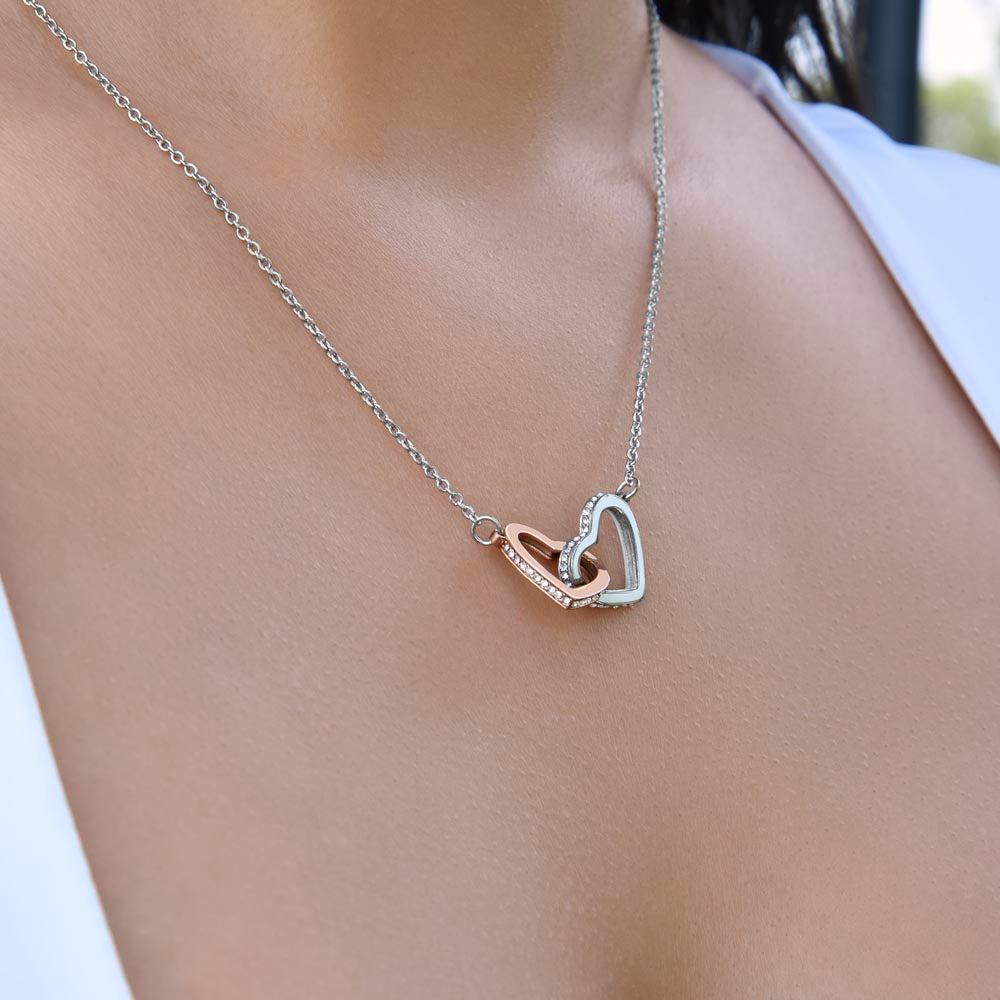To My Daughter, two lovely interlocking heart pendants embellished with CZ crystals. High quality polished surgical steel and rose gold finish.
