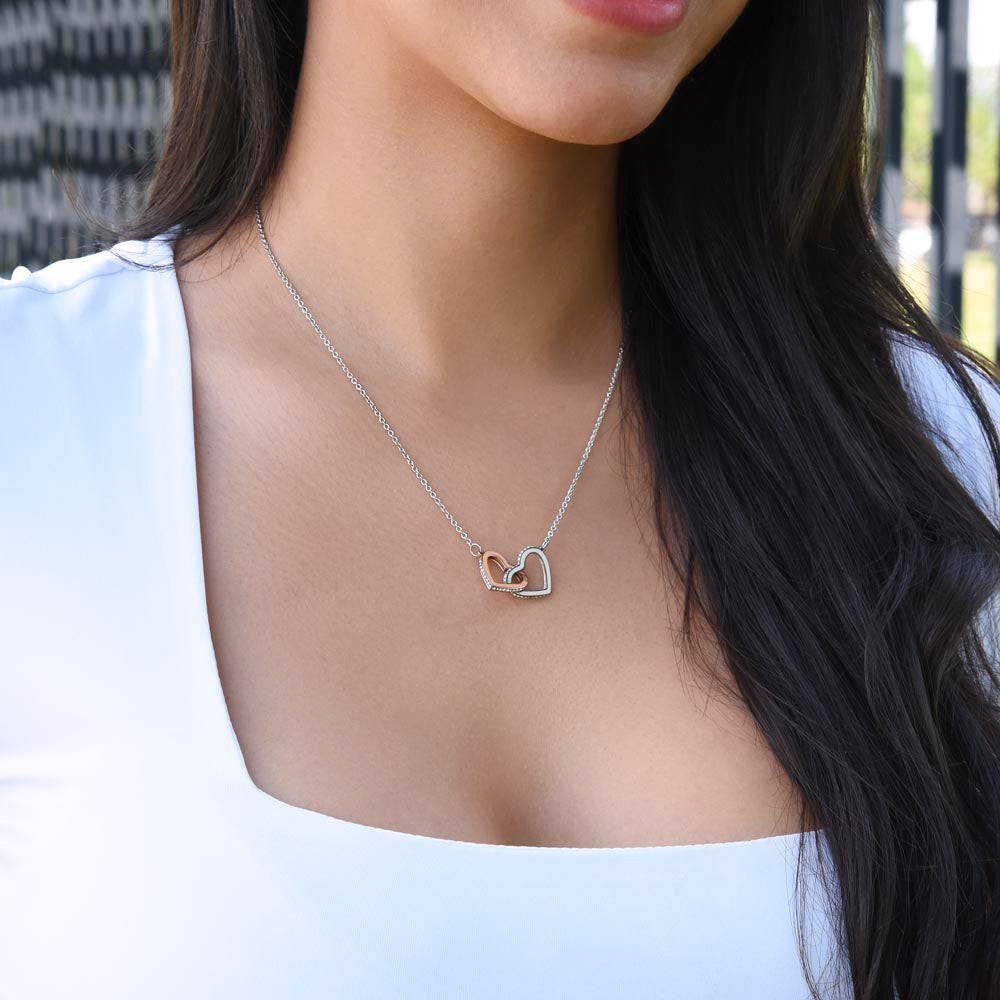 To My Daughter, two lovely interlocking heart pendants embellished with CZ crystals. High quality polished surgical steel and rose gold finish.