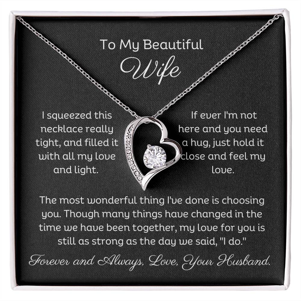 Dazzling Forever Love Necklace and heartfelt message card. This necklace features a stunning 6.5mm CZ crystal surrounded by a polished heart pendant embellished with smaller crystals. 14k white gold finish with adjustable chain length: 18" - 22" (45.72cm - 55.88cm)
