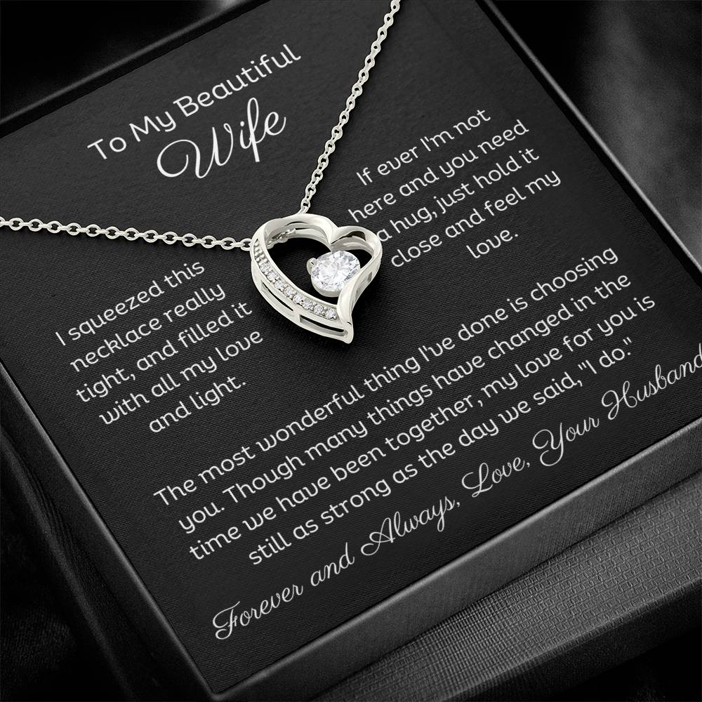 Dazzling Forever Love Necklace and heartfelt message card. This necklace features a stunning 6.5mm CZ crystal surrounded by a polished heart pendant embellished with smaller crystals. 14k white gold finish with adjustable chain length: 18" - 22" (45.72cm - 55.88cm)