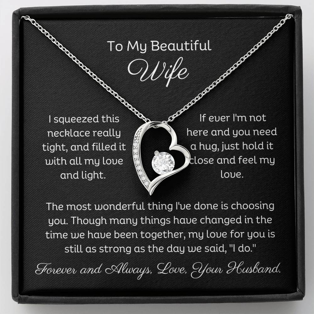 Dazzling Forever Love Necklace and heartfelt message card. This necklace features a stunning 6.5mm CZ crystal surrounded by a polished heart pendant embellished with smaller crystals. 14k white gold finish with adjustable chain length: 18" - 22" (45.72cm - 55.88cm)