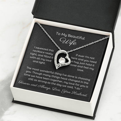Dazzling Forever Love Necklace and heartfelt message card. This necklace features a stunning 6.5mm CZ crystal surrounded by a polished heart pendant embellished with smaller crystals. 14k white gold finish with adjustable chain length: 18" - 22" (45.72cm - 55.88cm)