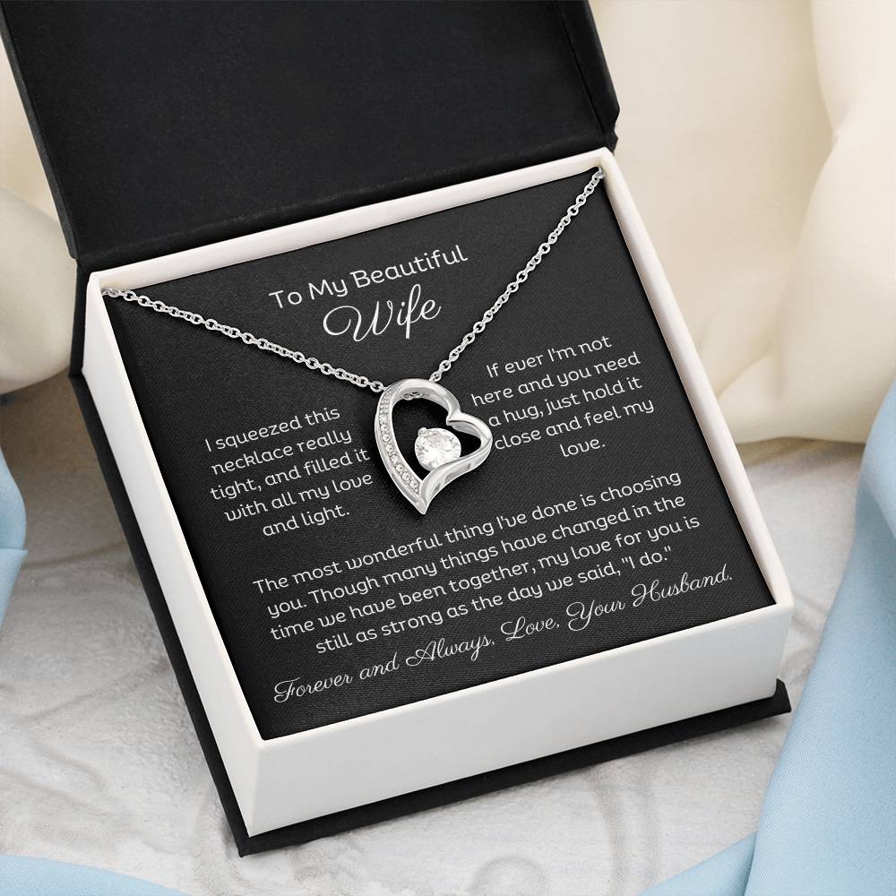 Dazzling Forever Love Necklace and heartfelt message card. This necklace features a stunning 6.5mm CZ crystal surrounded by a polished heart pendant embellished with smaller crystals. 14k white gold finish with adjustable chain length: 18" - 22" (45.72cm - 55.88cm)