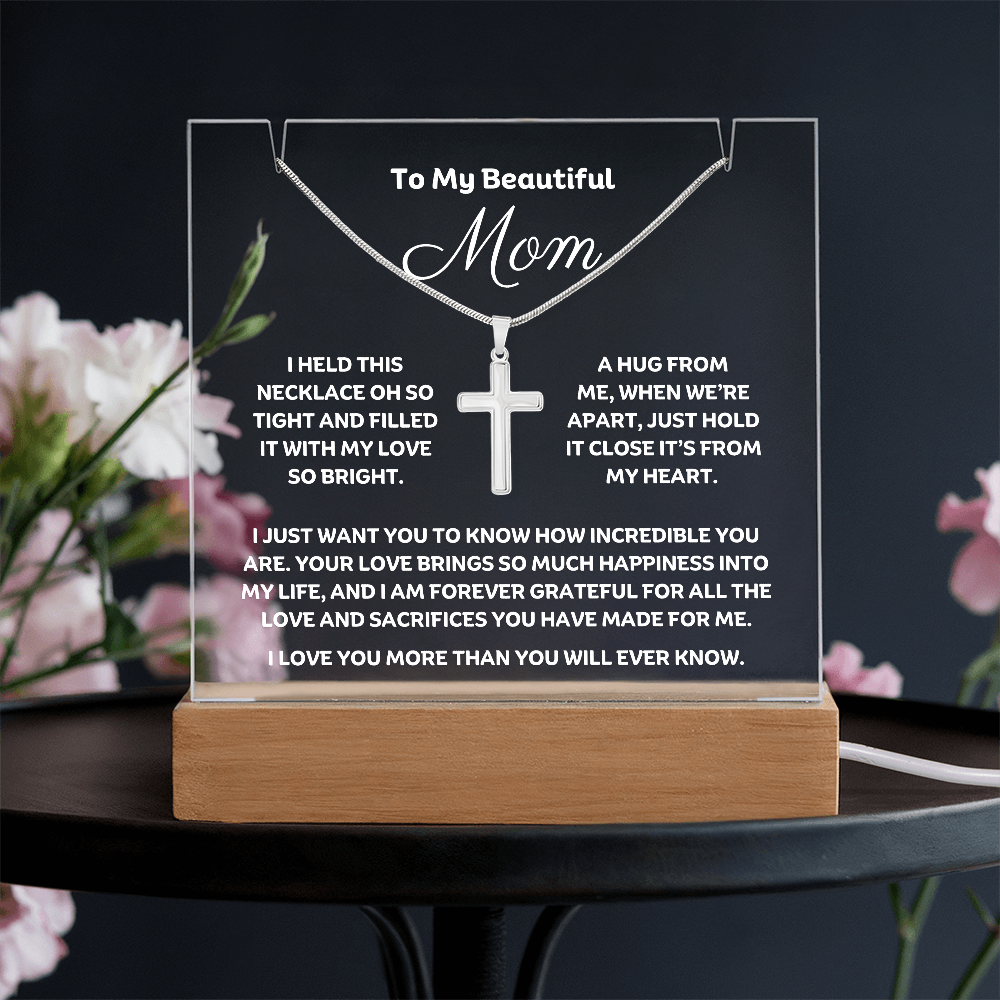 Show Mom how much you love her with this stunning Square Acrylic plaque paired with a beautiful Polished Stainless Cross Pendant Necklace. The beautiful Mom heartfelt message is showcased on crystal-clear acrylic with 7 colour LED lighting, making this set a striking focal point in any space. 