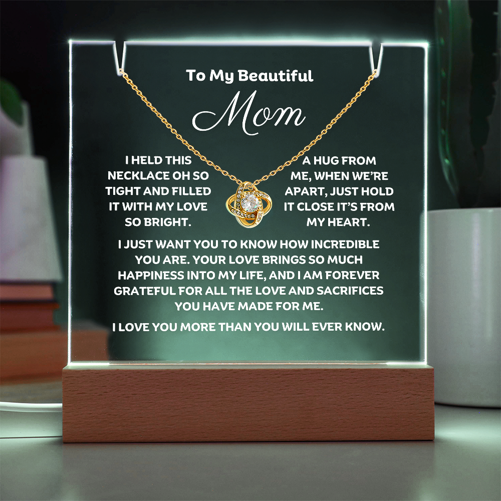A stunning Square Acrylic and the beautiful Love Knot Necklace for Mom. The beautiful mom heartfelt message is showcased on crystal-clear acrylic, making this set a striking focal point in any space. Paired with the charming Love Knot Necklace.