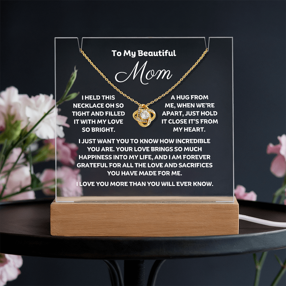 A stunning Square Acrylic and the beautiful Love Knot Necklace for Mom. The beautiful mom heartfelt message is showcased on crystal-clear acrylic, making this set a striking focal point in any space. Paired with the charming Love Knot Necklace.