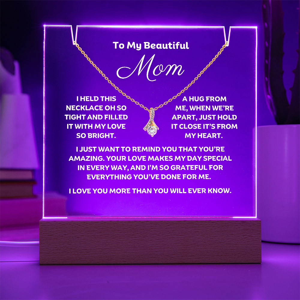 A stunning Square Acrylic plaque paired with the beautiful Alluring Beauty Pendant, Embellished With Cubic Zirconia Crystals Necklace for Mom. The beautiful mom heartfelt message is showcased on crystal-clear acrylic, making this set a striking focal point in any space. Paired with the charming Alluring Beauty Necklace.
