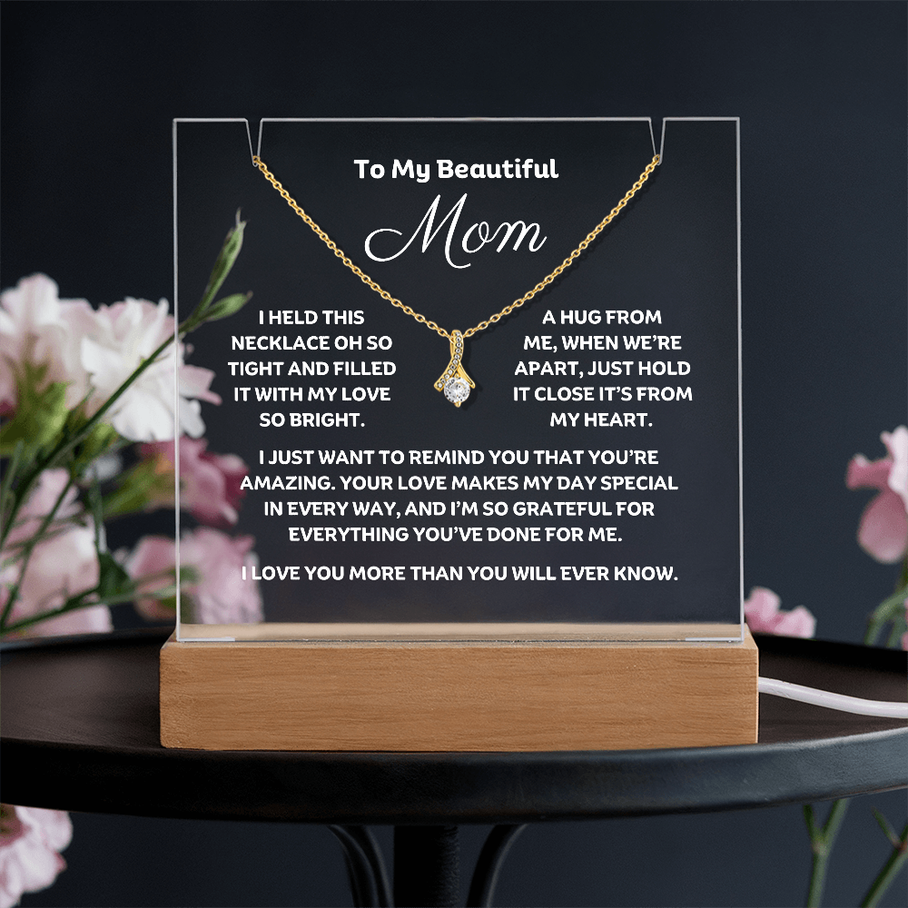 A stunning Square Acrylic plaque paired with the beautiful Alluring Beauty Pendant, Embellished With Cubic Zirconia Crystals Necklace for Mom. The beautiful mom heartfelt message is showcased on crystal-clear acrylic, making this set a striking focal point in any space. Paired with the charming Alluring Beauty Necklace.