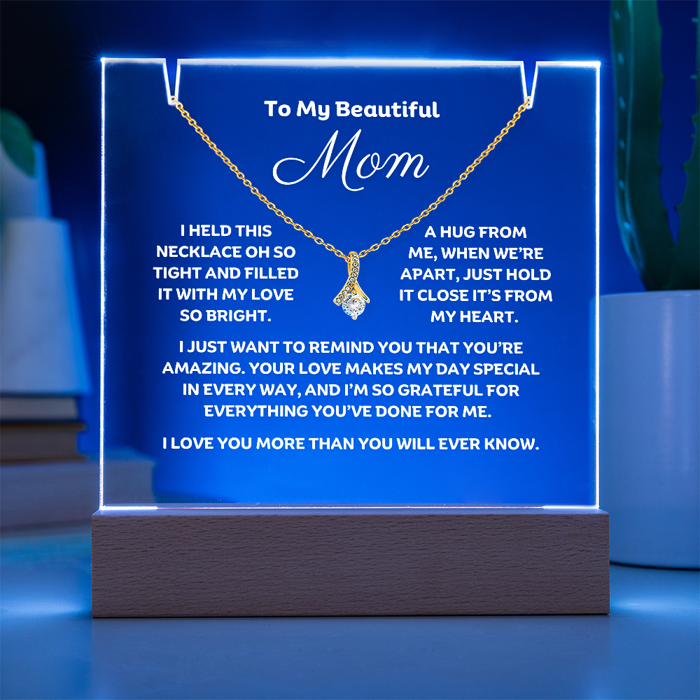 A stunning Square Acrylic plaque paired with the beautiful Alluring Beauty Pendant, Embellished With Cubic Zirconia Crystals Necklace for Mom. The beautiful mom heartfelt message is showcased on crystal-clear acrylic, making this set a striking focal point in any space. Paired with the charming Alluring Beauty Necklace.