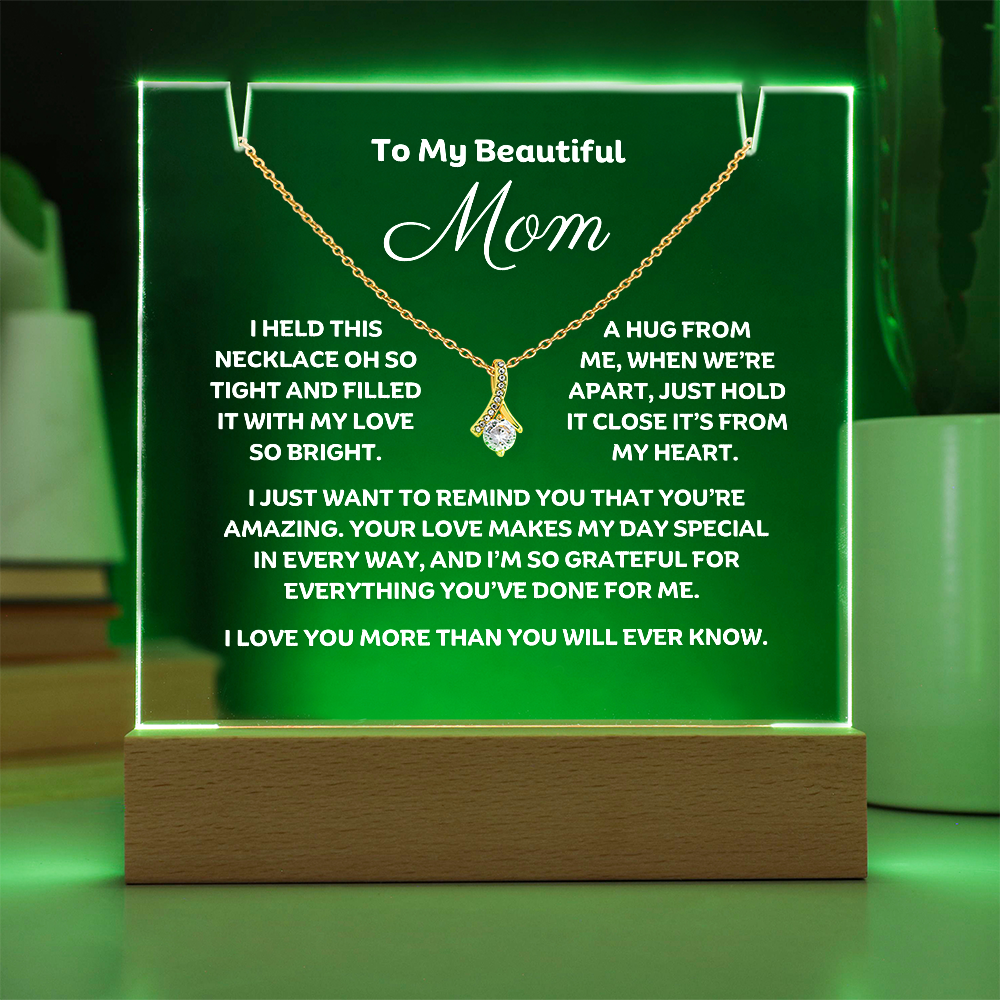A stunning Square Acrylic plaque paired with the beautiful Alluring Beauty Pendant, Embellished With Cubic Zirconia Crystals Necklace for Mom. The beautiful mom heartfelt message is showcased on crystal-clear acrylic, making this set a striking focal point in any space. Paired with the charming Alluring Beauty Necklace.
