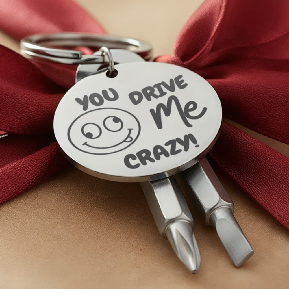 Engraved keychain screwdriver for your loved one with flathead and Philips. Cheeky message reads You drive me crazy! with a googly face. Add your own engraved message on the back. Colour Black or Silver.